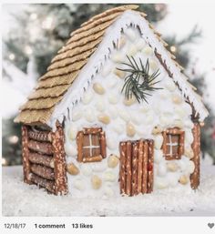 a gingerbread house is made to look like it has snow on the roof and windows