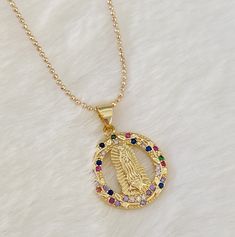 "18k Gold filled Our lady of Guadalupe necklace MATERIAL AND SIZE: 18k Gold filled chain Cubic Zirconia pendant Medal size: 2cm Length: 16\" or 18\". If you need other length, feel free to reach me out. If you have questions about the product, feel free to reach me out. Don't forget to check out my other items in the store: Https://www.etsy.com/shop/nyahwithlove" Gold Our Lady Of Guadalupe Pendant Necklace, Spiritual Yellow Gold Our Lady Of Guadalupe Jewelry, Gold Medallion Necklace With Our Lady Of Guadalupe, Spiritual Jewelry: Our Lady Of Guadalupe Round Pendant, Gold Medallion Necklace Of Our Lady Of Guadalupe, Gold Our Lady Of Guadalupe Round Pendant Necklace, Gold Our Lady Of Guadalupe Medallion Necklace, Lady Of Guadalupe Necklace, Profile Deep