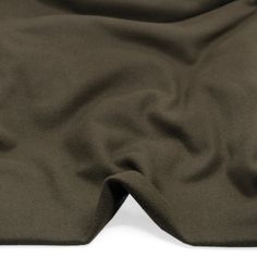 Made from a cozy blend of wool & nylon, this deadstock felted coating is a surefire pick for all kinds of lined and unlined coats or jackets. With a structured drape, this medium weight coating is thick & warm with a beautiful soft hand. Easy to sew, it also boasts a minimal fray edge that would work well for a raw finish.This fabric has been sustainably sourced from a deadstock fabric supplier. For a professional finish, pair with our solid Bemberg Cupro Linings. Gütermann Thread Match: #580 Bitter Chocolate Content: 80% Wool / 20% Nylon *Exact contents cannot be guaranteed Width: 147cm / 58”Weight: 434gsm / 12.8ozOpacity: OpaqueDrape: StructuredCountry of Origin: Italy Share your makes with #BFWool, #BFDeadstock, and #BlackbirdFabrics! Wool Fabric Texture Textiles, Soft Brown Fabric, Green Wool Fabric, Black Wool Fabric, Brown Boucle Fabric, Deadstock Fabric, Bitter Chocolate, Fabric Suppliers, Easy To Sew