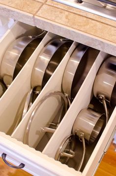 an open drawer filled with silverware in a kitchen