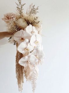 a person holding a bouquet of flowers in their hand