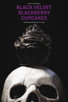 a black velvet cupcake sitting on top of a white skull's head with the words black velvet cupcakes above it