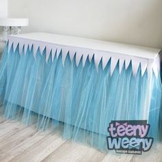 there is a table that has some blue tulle on it