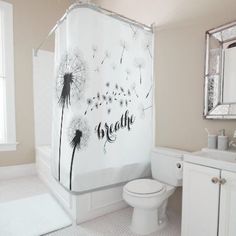 a bathroom with a dandelion shower curtain