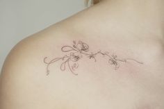 a woman's chest with flowers on it and the word love written in cursive writing