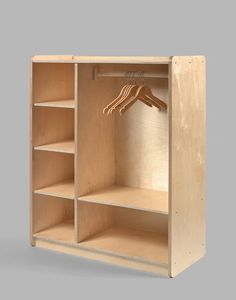 an open wooden wardrobe with clothes hanging on the hanger and hands reaching for something