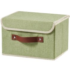 a green storage box with brown leather handles