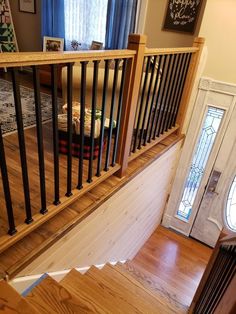 the stairs are made of wood and have black railings