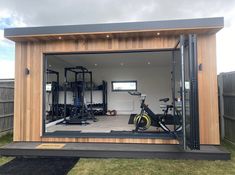 a home gym with an exercise bike in the back door and other equipment on display