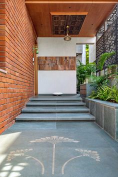 an entry way with steps leading up to the building and potted plants on either side