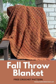 an orange blanket sitting on top of a wooden chair