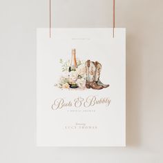 a wedding card with boots and flowers on the front is hanging from a string that reads, best & beautiful