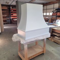 a large white chimney sitting on top of a wooden shelf