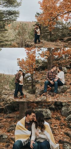 two people are sitting on rocks in the woods and one person is holding his baby