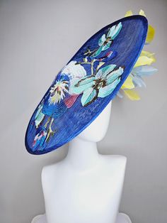 From the 2024 Featured Milliner of the Kentucky Derby Museum  Gorgeous Kentucky Derby hat fascinator  kentucky derby hat fascinator blue sinamay saucer with yellow and light blue feathers and blue blue white pink yellow embroidered flowers headband attachment.  each hat is totally one of a kind! no two are alike! *All hats are sold as displayed. No returns do to nature of product (headwear) Of course do not hesitate to contact me with any issues :) Check out my The Hat Doctor amazing news story Whimsical Blue Mini Hats For Spring, Blue Whimsical Mini Hats For Spring, Luxury Blue Hat For Kentucky Derby, Blue Feather Trim Hat For Kentucky Derby, Blue Feathered Fascinator For Spring, Luxury Yellow Hat Fascinator, Spring Blue Feathered Fascinator, Blue Wide-brim Fascinator For Kentucky Derby, Derby Hats Fascinators