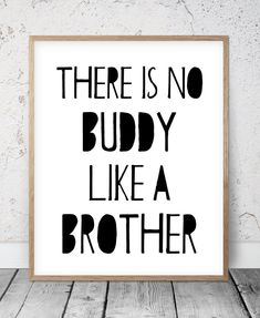 there is no buddy like a brother print in black and white on a wooden frame