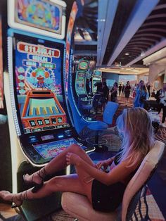 a woman sitting in front of a slot machine