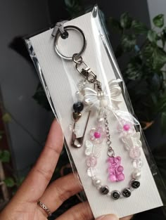 the key chain is decorated with beads and bows