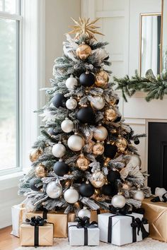 a christmas tree decorated with black and white ornaments, gold and silver baubons