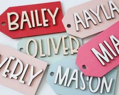 four tags with names on them that say,'bailey, avana, oliver, and harley mason