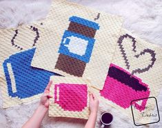 three crocheted coasters with coffee mugs on them, one is pink and the other is blue