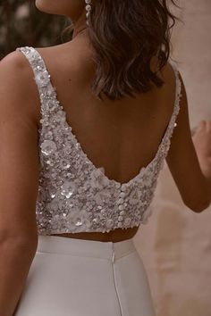 the back of a woman's dress with sequins on it