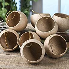 six wooden bowls sitting on top of a table next to each other with string wrapped around them