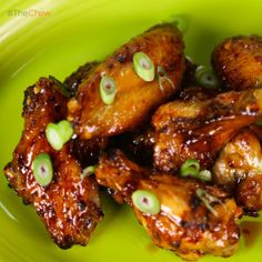 chicken wings with green olives on a green plate