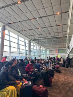 many people are waiting for their luggage at the airport