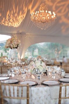 the tables are set with white and gold linens for an elegant wedding breakfasteon