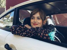 a woman sitting in the passenger seat of a car