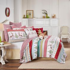 a bed room with a neatly made bed next to a white fireplace and a chair