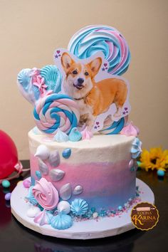 a dog is sitting on top of a colorful cake