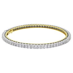 The Classic & Evergreen Bangle that delicately accentuates the wrist. This bangle is open-able for ease of putting on and taking off. Total Diamond Weight: 5.03 ct No. of Diamonds: 72 Average Diamond Weight: 0.07 ct Diamond Color: H Diamond Clarity: VVS - VS (Very Very Slightly Included - Very Slightly Included) Metal: 14K White & Yellow Gold Metal Wt: 12.20 gms Setting: Prong Set Inner Diameter: 2.25 Inches (5.72 cms) Openable with double lock system for added security Double Lock, Diamonds And Gold, Diamond Bangle, Tennis Bracelet, Diamond Clarity, Womens Bracelets, Prong Setting, Colored Diamonds, Metallica