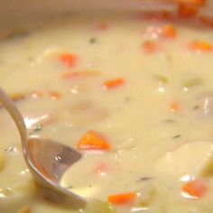 a close up of a spoon in a bowl of soup