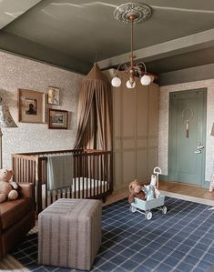 a baby's room with a crib, rocking chair and teddy bear on the floor