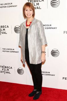 a woman standing on top of a red carpet