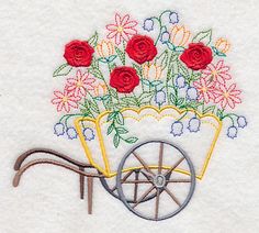 a wheelbarrow with flowers in it is embroidered onto the side of a towel