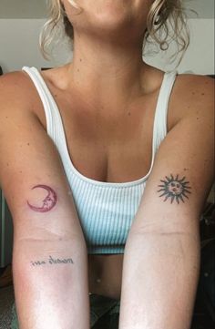 a woman with two tattoos on her arms and one has a sun and moon tattoo