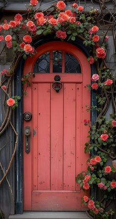 an orange door with pink flowers growing over it