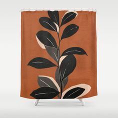 an orange shower curtain with black and white leaves on the front, against a brown background