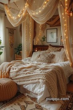 a bed with lights hanging from the ceiling and pillows on the floor in front of it