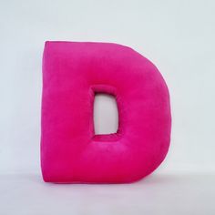 a pink pillow shaped like the letter d