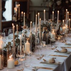 a long table is set with candles and place settings