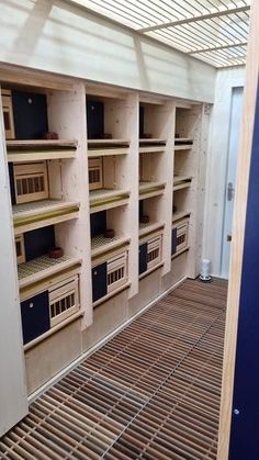 an empty room filled with lots of wooden shelves