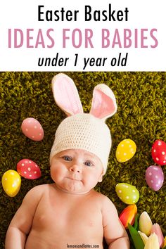 a baby wearing an easter bunny hat and sitting on the grass with eggs around it