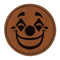 a brown and black clown face on a white background