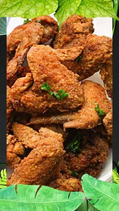 some fried food on a white plate with green leaves in the background and an advertisement for chicken