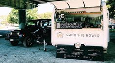 an ice cream truck is parked under a bridge with its food cart on it's side