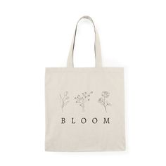 a tote bag with the words bloom printed on it and flowers in black ink